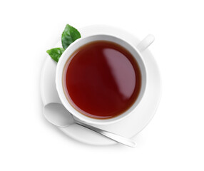 Cup of aromatic black tea, spoon and green leaves on white background, top view