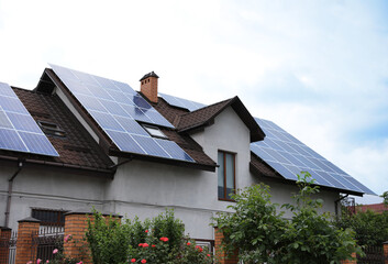 House with installed solar panels on roof. Alternative energy source © New Africa