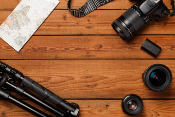 top view of travel photographic equipment on wooden background