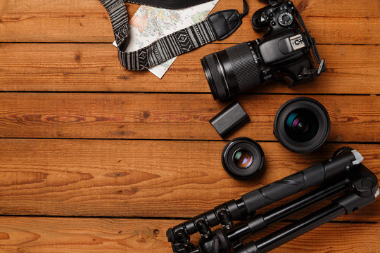 top view of travel photographic equipment on wooden background