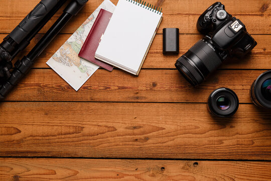top view of travel photographic equipment on wooden background