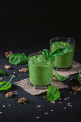 Homemade spinach smoothie on dark background