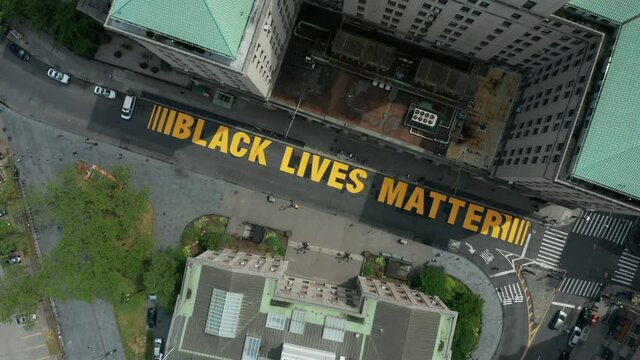 spinning and descending over BLM sign painted on Joralemon St. in downtown Brooklyn