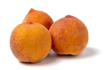 Peaches. Three juicy peaches isolated on a white background closeup.