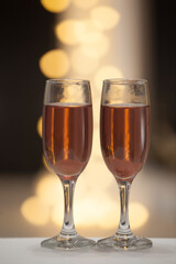 Two glasses of pink champagne for the couple.