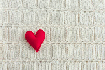 small red decorative felt heart on a soft background. Valentine's day.