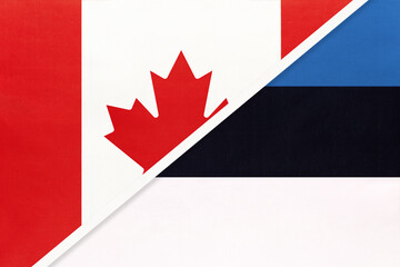 Obraz premium Canada and Estonia, symbol of national flags from textile. Championship between two countries.