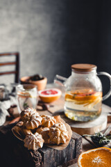 Naklejka na ściany i meble Tasty cakes with Hot tea with slices of fresh grapefruit on wooden tablet. Healthy drink, Eco, vegan