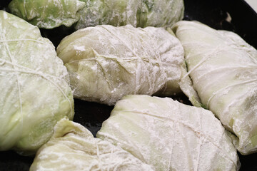 Fototapeta na wymiar Preparing stuffed cabbage, Polish cuisine specialty.