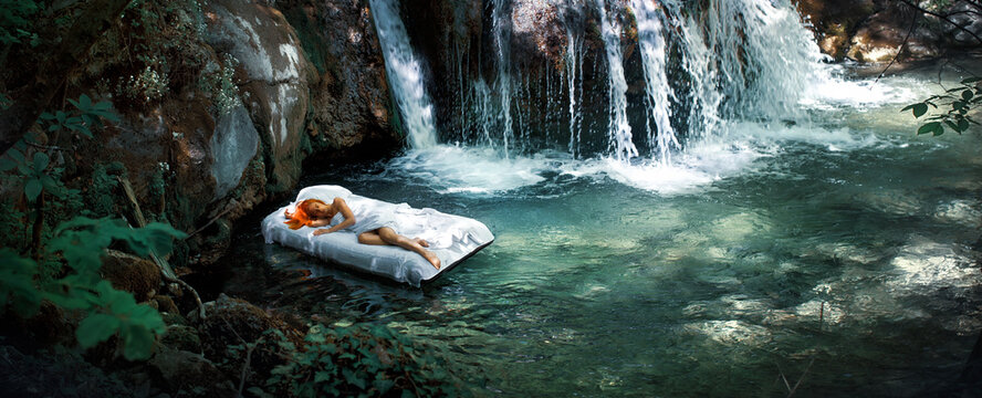  a Hidden place. Sleeping woman in deep forest sleep on airbed at pond by waterfall