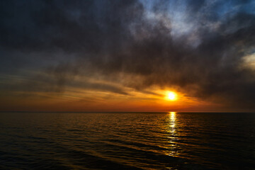 Sea sunset. Smoke wildfires sweeping across the sky.