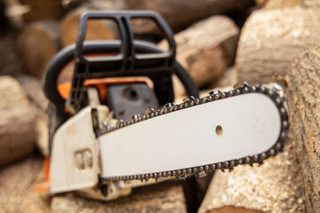 Chainsaw in action cutting wood. Man cutting wood with saw, dust and movements. Chainsaw. Close-up...