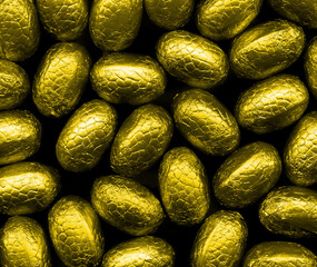 Closeup of foil wrapped chocolate easter eggs on a plain background