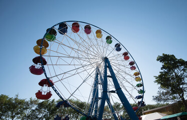 Fototapeta premium A colourful Ferris wheel in the city park.