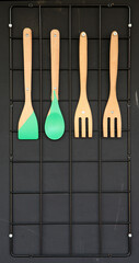 Cooking and eating kitchen utensils in plastic, metal and wood on a plain background