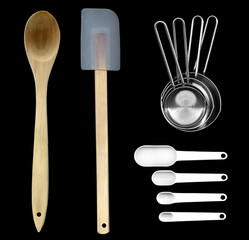Cooking and eating kitchen utensils in plastic, metal and wood on a plain background