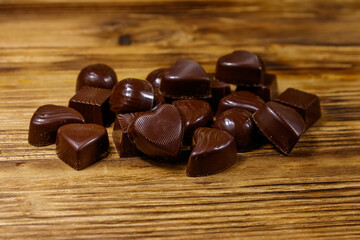 Tasty chocolate candies on wooden table