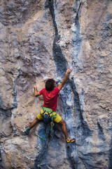 Obraz premium A strong man climbs a rock, Rock climbing in Turkey.