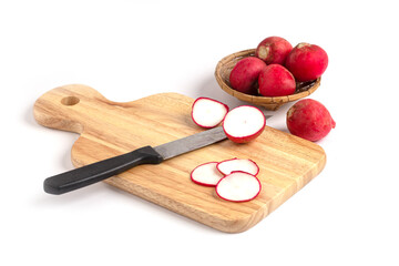 Sliced Radishes on cutting board with knift on white background