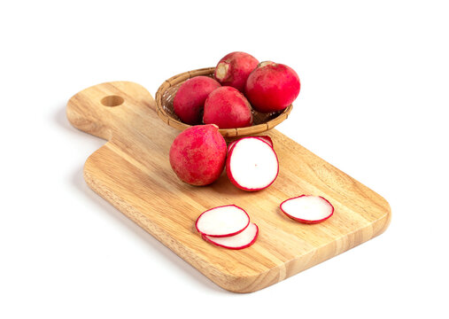 Sliced Radishes on cutting board on white background