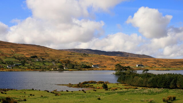 Irish landscape with a lake, puffy clouds, typical scene from Connemara