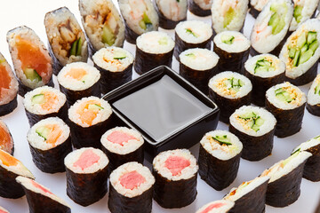 Various kinds of sushi roll set served on cutting board. Japanese food