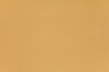 Dark yellow wall, texture, background. The building wall, painted with water-based paint. Smooth (flat) surface in yellow color with golden brown, flaxen and wheat tint or shade