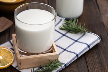 milk in glass on wood food background