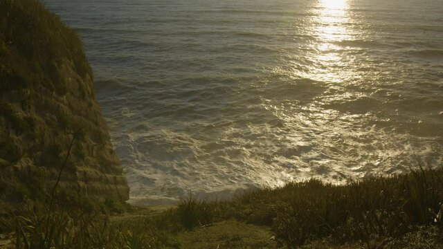 Slow motion 48fps - Cliff views of crashing waves near Greymouth New Zealand - Sunset// Static- Wide Shot