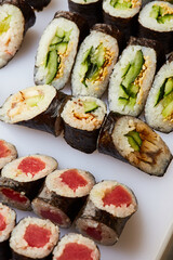 Various kinds of sushi roll set served on cutting board. Japanese food