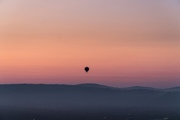 The silhouette of a hot air balloon during sunrise.