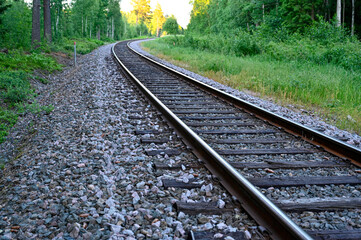 low perspective of rail tracks into a bend