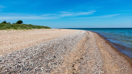 traditional summer landscape with sandy and pebbly promontory, blue sea and sky, Harilaid Nature Reserve, Estonia, Baltic Sea