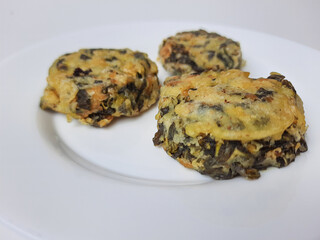 Rolade daun singkong, is a fried food from Indonesia. Made from cassava leaves, tofu and flour. Isolated in white background.