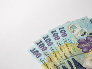Many 100 RON or lei romanian banknotes on white background. Romanian currency.