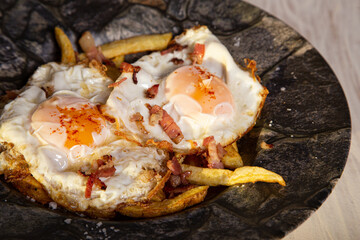 scrambled eggs with ham and fried potatoes. spanish cuisine.