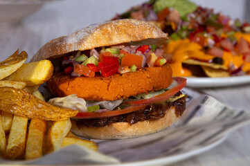 Close up of delicious vegan homemade burgers on a wooden table.