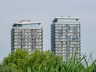 Natural delta between apartment blocks with skyscrapers in the background, in Bucharest, Romania.