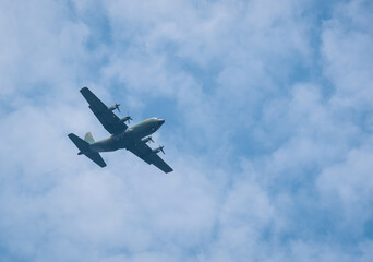 Large military cargo plane flying over Bucharest. Plane prepairing for landing.