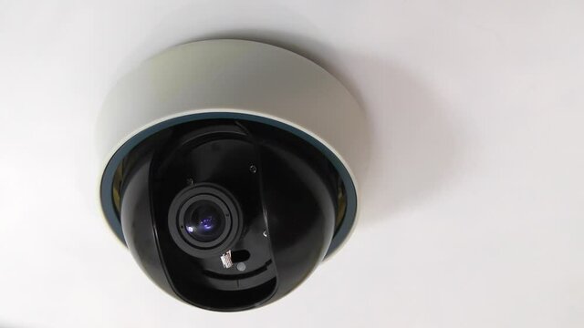 Ceiling video camera. Security. CCTV camera approaching.