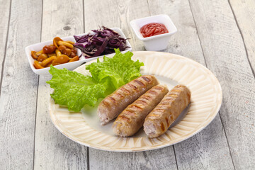 Grilled sausages served mushrooms and cabbage