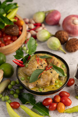 Chicken green curry in a bowl .