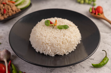 Spicy minced pork and rice on a black plate.