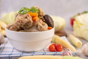 Pork ball soup in a cup on a blue-white cloth.