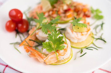 Spicy salad with shrimp on a white plate. Thai food.