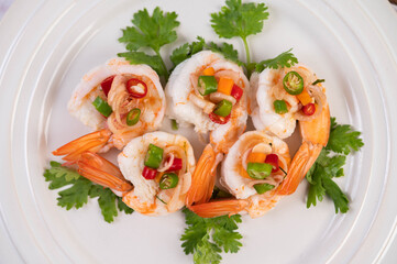 Spicy salad with shrimp on a white plate. Thai food.