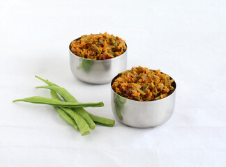 Cluster beans curry, also known as gawar ki sabzi, is a healthy, Indian, and vegetarian side dish for items like chapathi and roti, in steel bowls.
