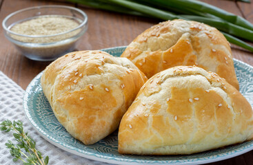 Delicious Uzbek samsa with meat and onions sprinkled with sesame on the table.