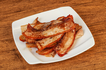 Roasted juicy bacon in the plate