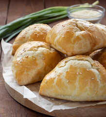 Delicious Uzbek samsa with meat and onions sprinkled with sesame on the table.